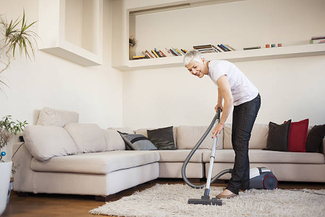 cleaning lady with vacuum cleaner